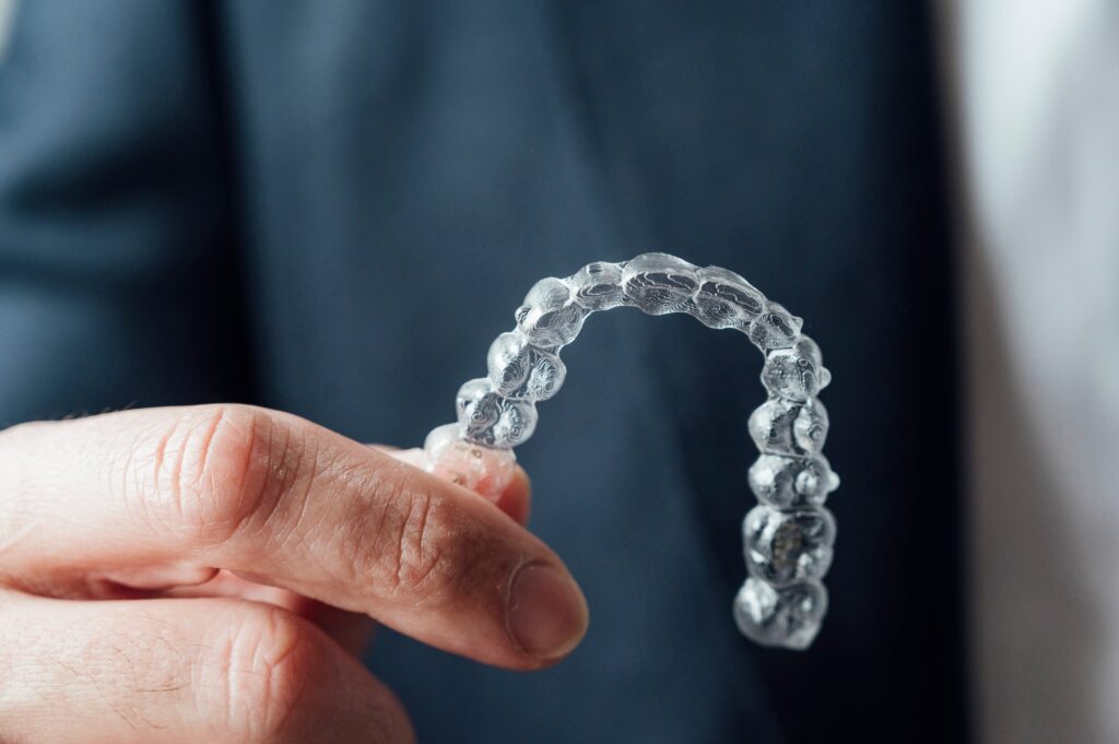 Professional showing dental clear aligners.